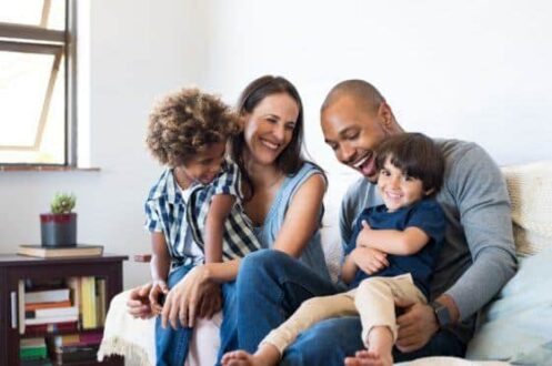 family sitting on couch inside house